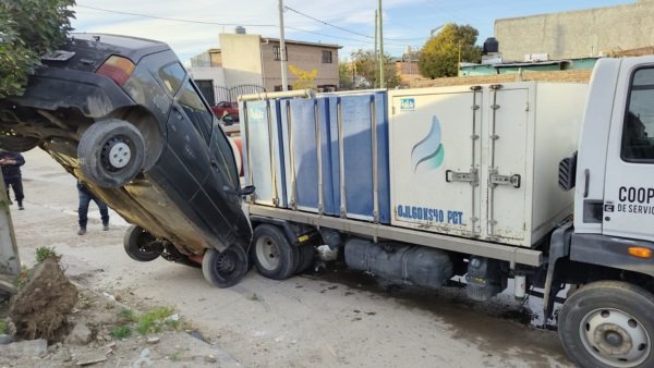 Insólito accidente: un auto terminó colgado de un poste tras un choque por escarcha